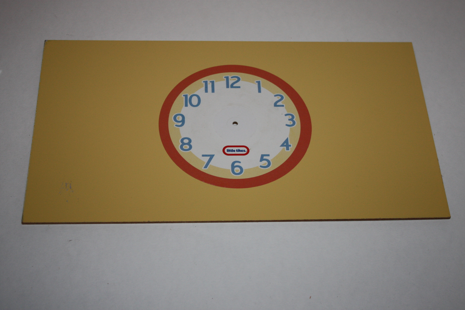 Clock (yellow wall) with clock hands Image